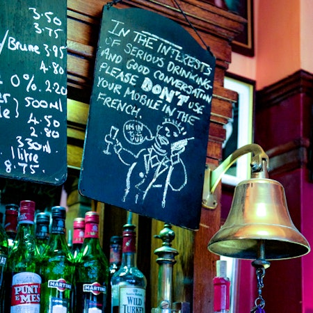 A sign over the bar that reads: “In the interests of serious drinking and good conversation, please don’t use your mobile in the French.”