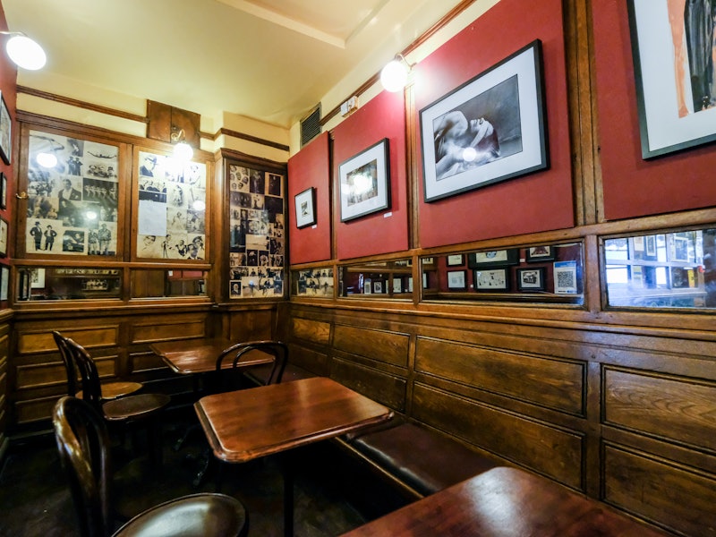 Tables and photographs at The French House in London, UK