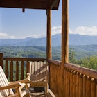 Rocking chairs invite relaxation with a view of the Smoky Mountains.
157383124
Home Ownership, Deck, No People, Looking At View, Two Objects, Rustic, Remote, Rocking Chair, Great Smoky Mountains, Cabin, Scenics, Awe, Getting Away From It All, Relaxation, Solitude, Tranquil Scene, Wood - Material, Empty, Pair, Architecture, Vacations, Lifestyles, Wide Angle, Recreational Pursuit, Summer, Mountain, Woodland, Great Smoky Mountains National Park, Cloud - Sky, Porch, Nature, Travel Locations, Architecture And Buildings, Nature Symbols/Metaphors, Travel Backgrounds, Architectural Detail, Log Cabin