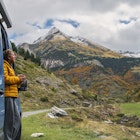 A mature man, parked up in his campervan above Gavarnie in the Hautes-Pyrenees, takes in the view of the surrounding mountains. He wears a yellow puffer jacket and holds a hot drink.
1776564269
pic du piméné