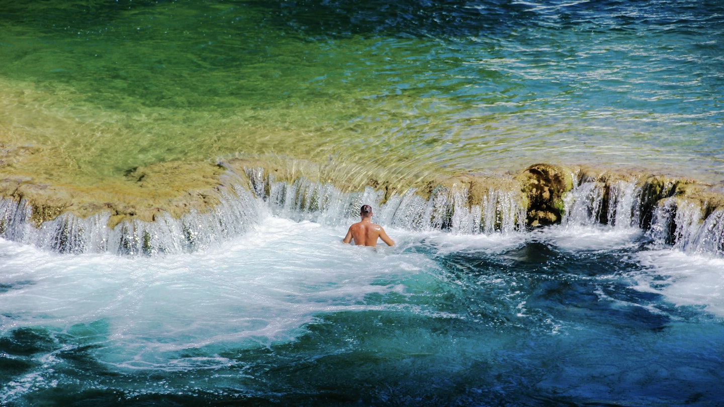 Man standing in water near small waterfalls in Krka National Park
Getty,  RFC,  People Cold Temperature Motion Adventure Enjoyment Lifestyles Horizontal Outdoors Swimming Rippled Water Winter Wave Surf Reflection Sea Croatia Turquoise Colored One Person Color Image Splashing Leisure Activity Photography Zadar Power in Nature 2015,  Back,  Nature,  Outdoors,  Person,  Photography,  Rock,  Sea,  Sea Waves,  Summer,  Swimming,  Swimwear,  Water
Man standing in water near small waterfalls in Krka National Park