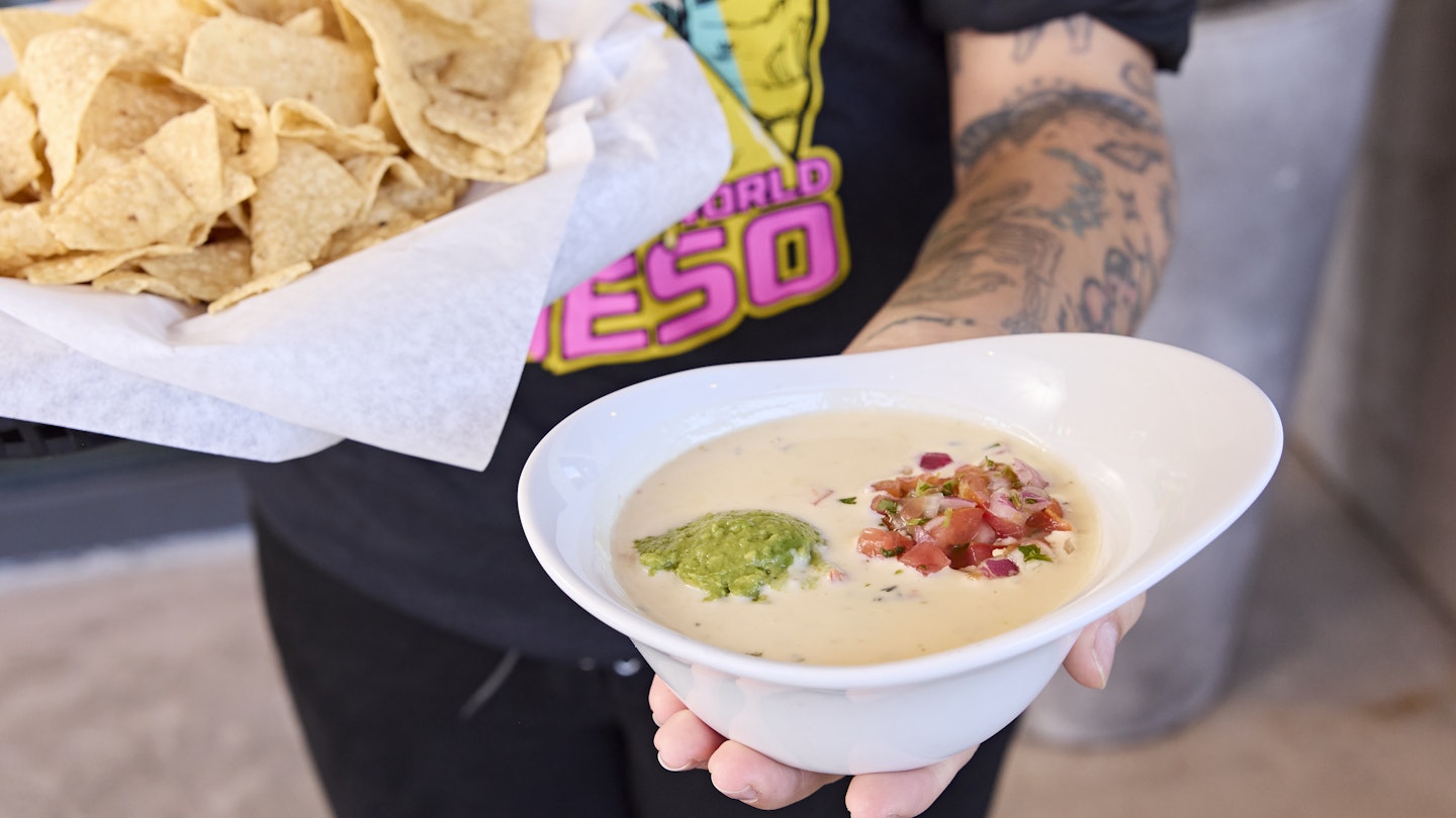 Kerby Lane, queso shirt with dish of queso