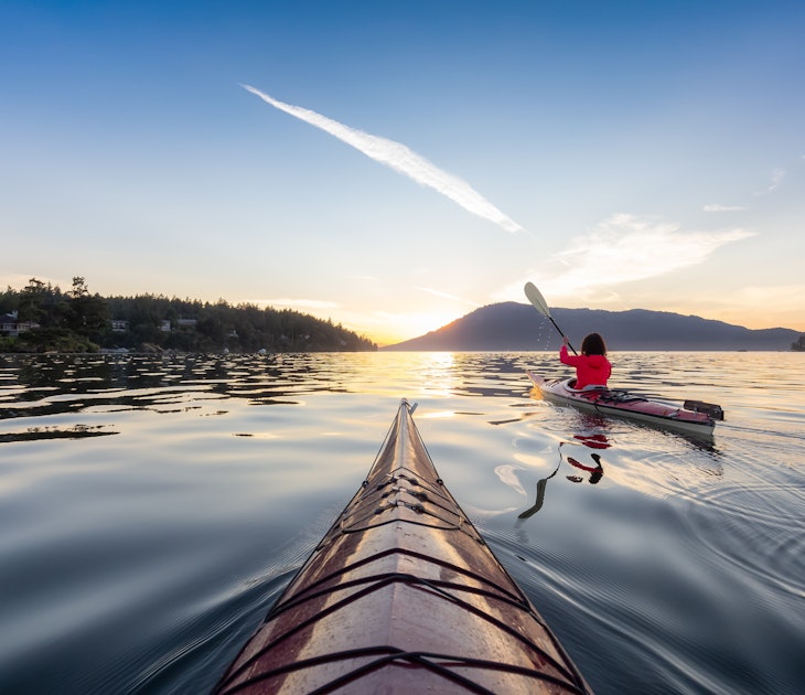 Adventurous Woman on Sea Kayak paddling in the Pacific Ocean. Sunny Summer Sunset. Taken near Victoria, Vancouver Islands, British Columbia, Canada. Concept: Sport, Adventure, License Type: media, Download Time: 2025-02-25T22:04:58.000Z, User: rhylton_redventures, Editorial: false, purchase_order: 56530 - Guidebooks, job: Lonely Planet WIP, client: Lonely Planet WIP, other: Rhianydd Hylton