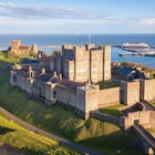 Dover, England, United Kingdom - May 10, 2021: View of Dover castle and harbour at sunset., License Type: media, Download Time: 2024-12-18T22:15:24.000Z, User: meg3348277, Editorial: true, purchase_order: 56530 - Guidebooks, job: Global Publishing-WIP, client: England 13, other: Megan Cassidy