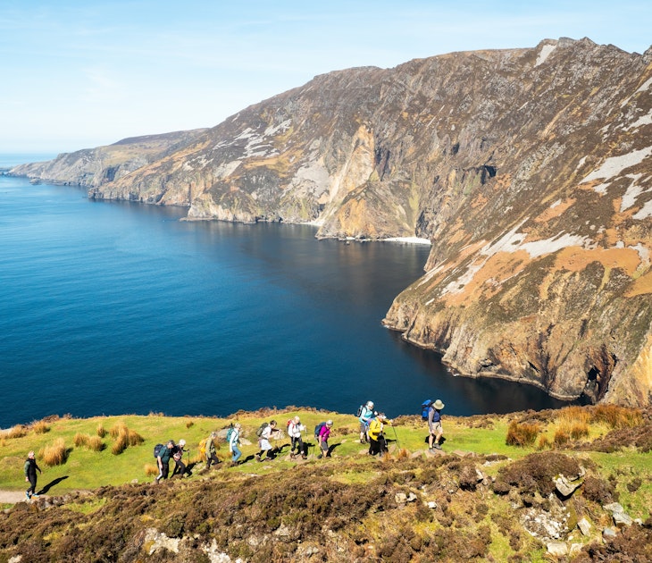 Sliabh Liag, Ireland - 04.21.2024: Group of hikers on footpath into mountains, beautiful cliff and ocean nature background. Travel and tourism industry. Warm sunny day., License Type: media, Download Time: 2024-11-26T12:04:08.000Z, User: clairenaylor, Editorial: true, purchase_order: 65050 - Digital Destinations and Articles, job: Online editorial, client: Ireland best things to do, other: Claire Naylor