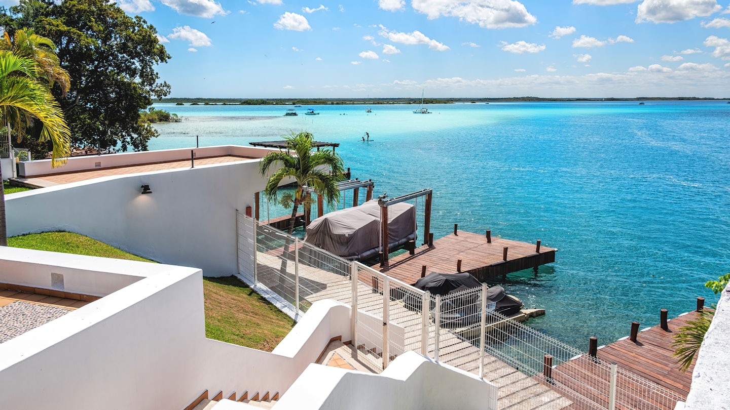 Houses and pier on the shore of the lagoon of Bacalar, Quintana Roo, Mexico, License Type: media, Download Time: 2025-01-30T21:29:45.000Z, User: Ppeterson948, Editorial: false, purchase_order: 56530 - Guidebooks, job: Global Publishing WIP , client: Global Publishing WIP , other: Pia Peterson Haggarty