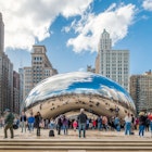 Tourists admire iconic Cloud Gate at Millennium Park during early Spring.